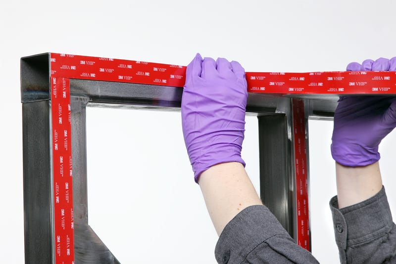 3M VHB tape being applied to a frame