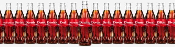 Coke bottles in a row with names on the labels