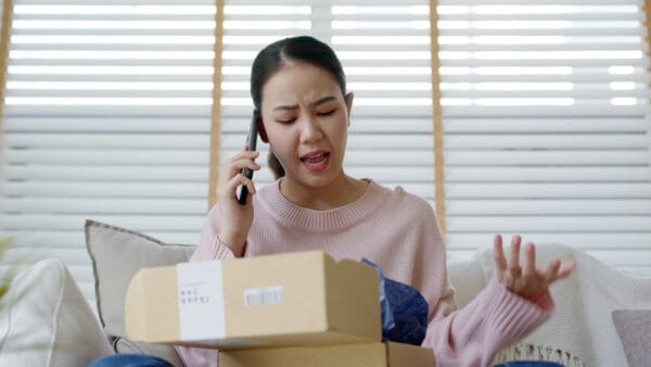 Person opens package sitting on couch
