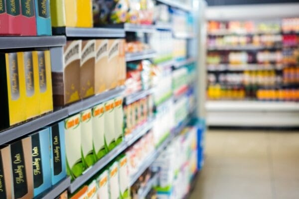 Supermarket shelves stacked with produce