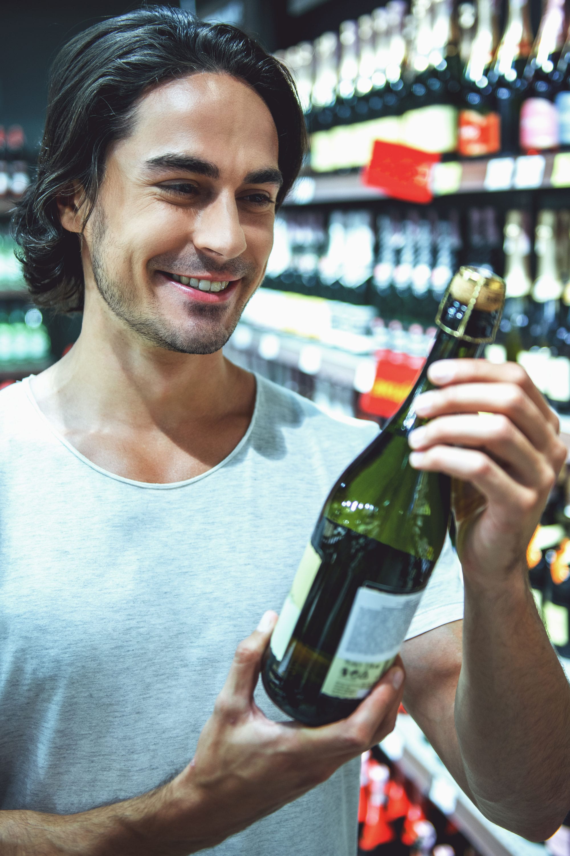Man views beverage Label on bottle
